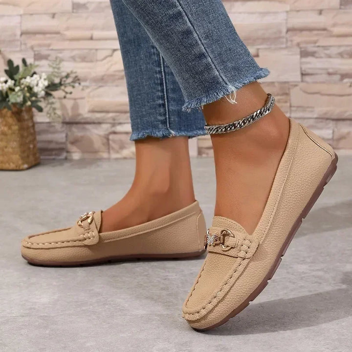 Women's slip-on loafers with round toe and butterfly buckle detail