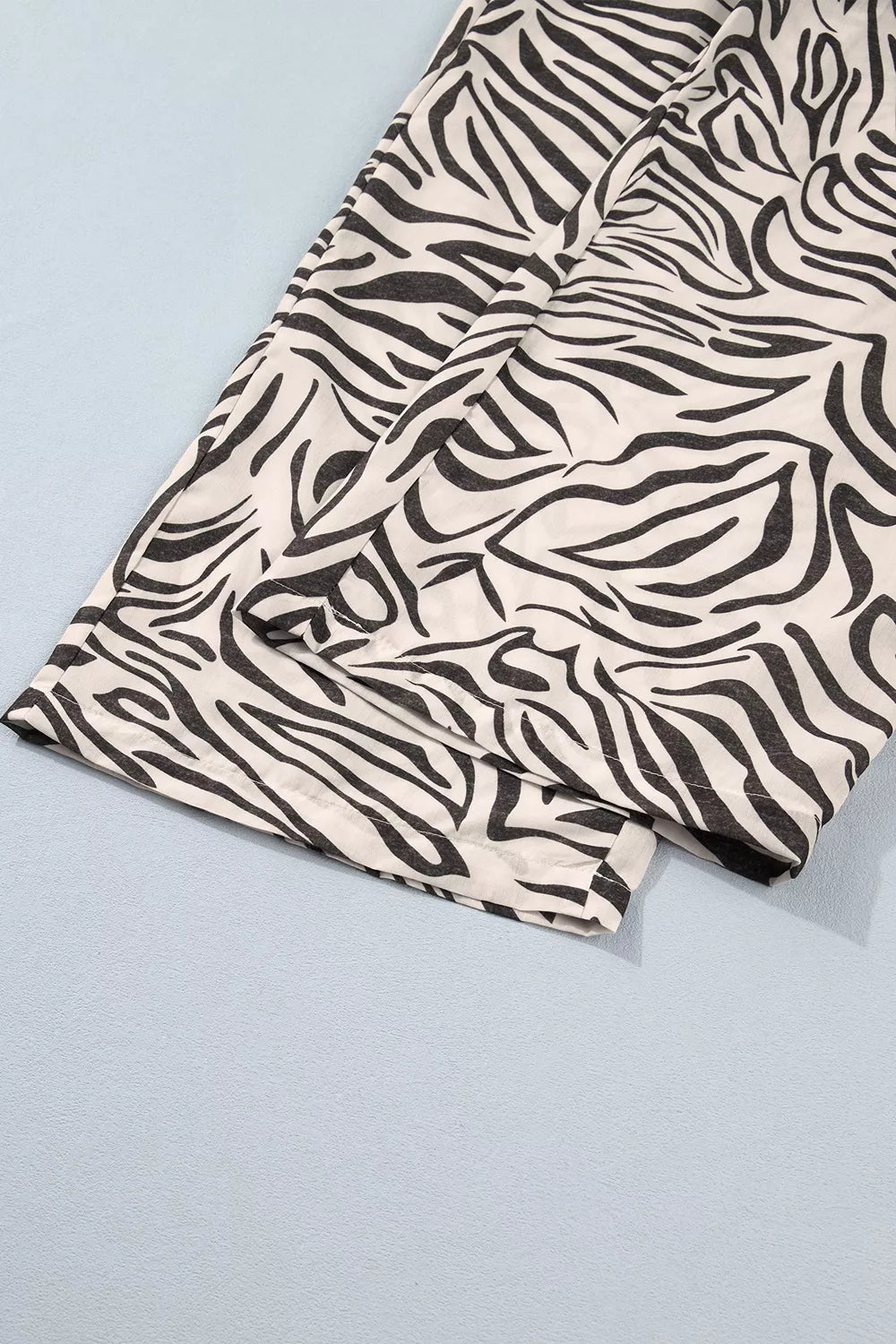 Zebra print wide leg hem folded flat showing the bold stripe pattern