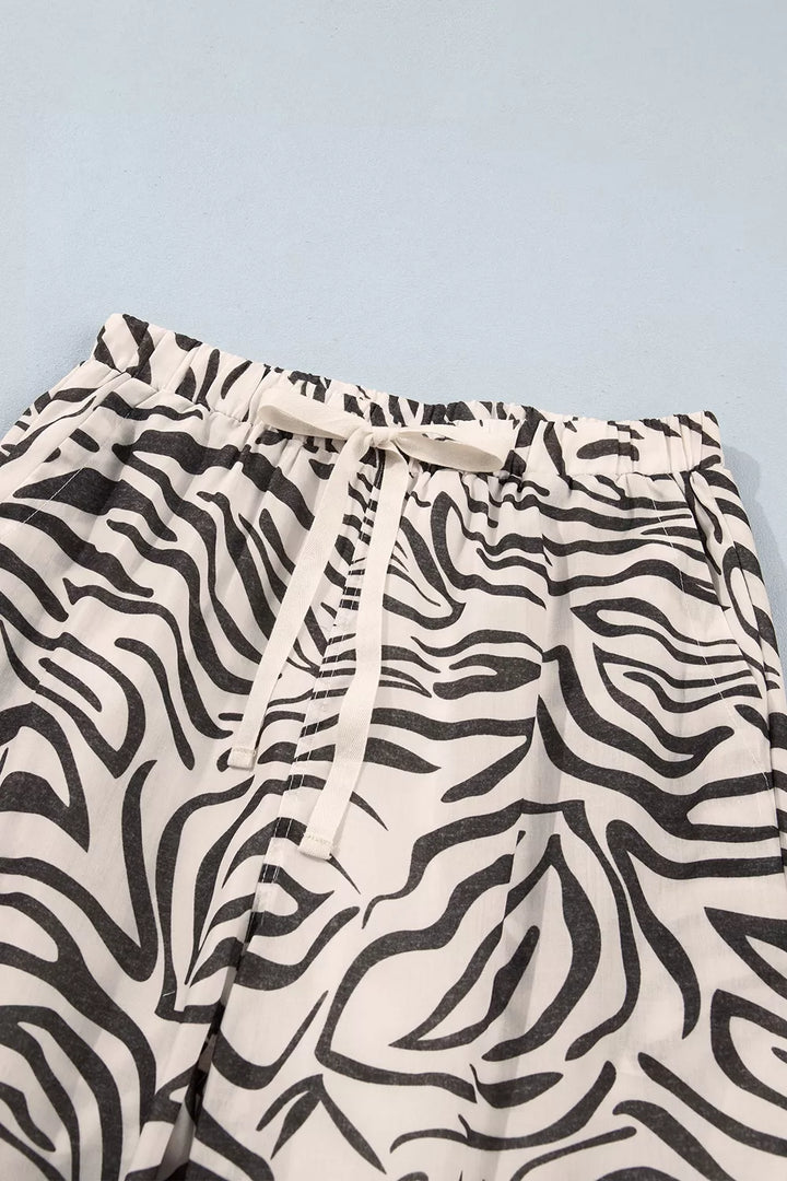 Zebra print pants drawstring waistband tied in a bow, close-up