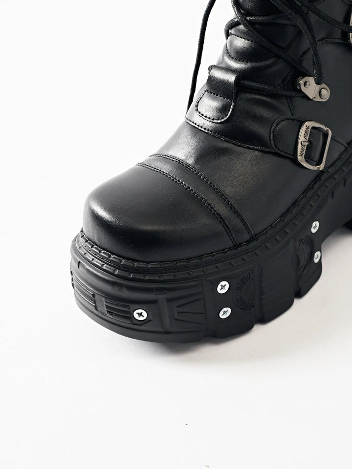 Close-up of the black boot toe cap and thick studded platform sole