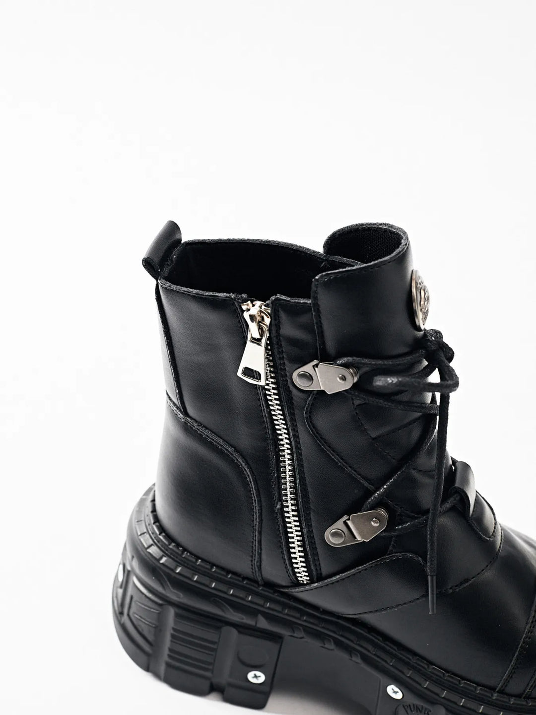 Black ankle boot side zipper and lace detail, angled view