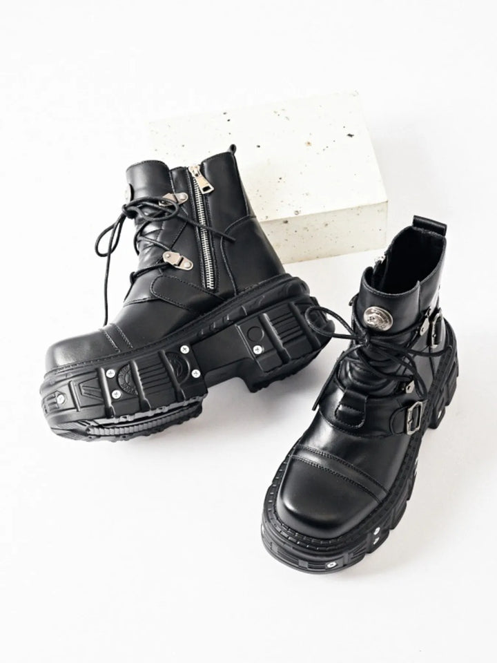 Black lace up platform boots shown as a pair with rivet trim on the sole