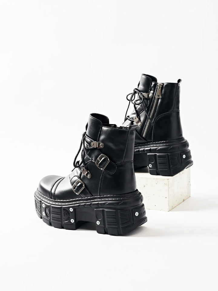 Black platform ankle boots standing together, one partly behind the other
