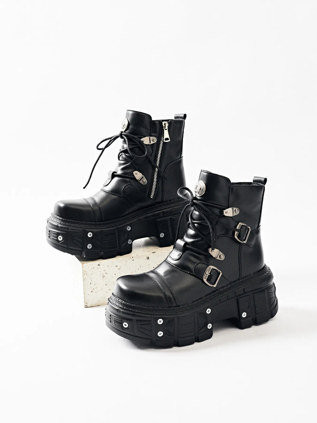 Black chunky platform boots with buckle style straps, pair on a block