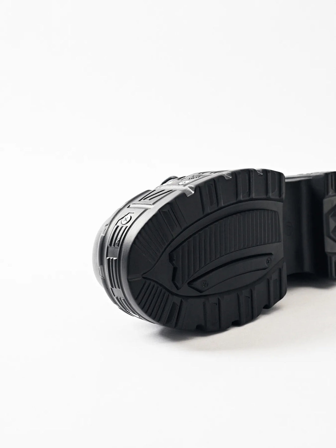 Black boot outsole with tread pattern, close-up of the platform sole