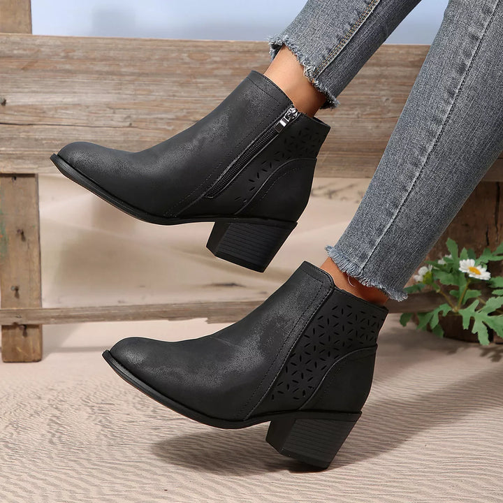 Black pointed toe ankle boots with block heel worn with jeans