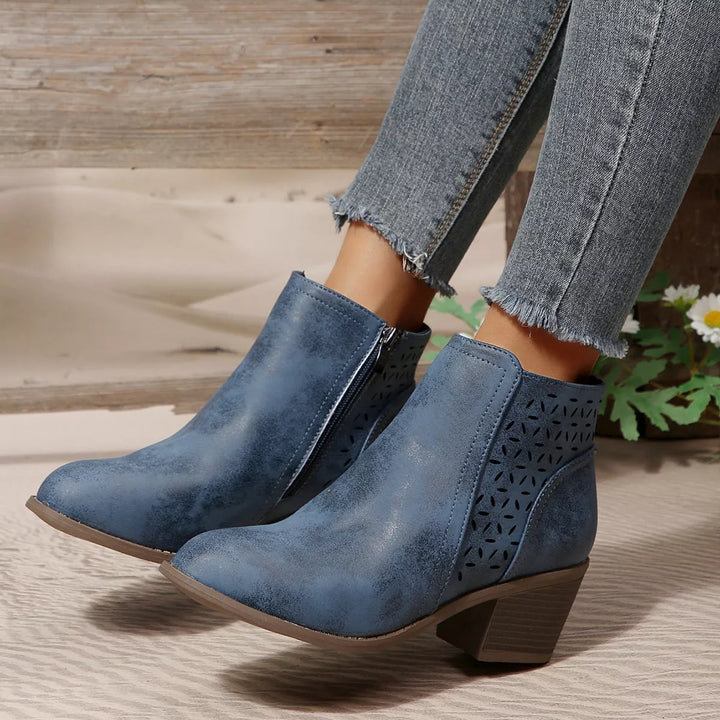 Denim blue pointed toe ankle boots worn with frayed jeans