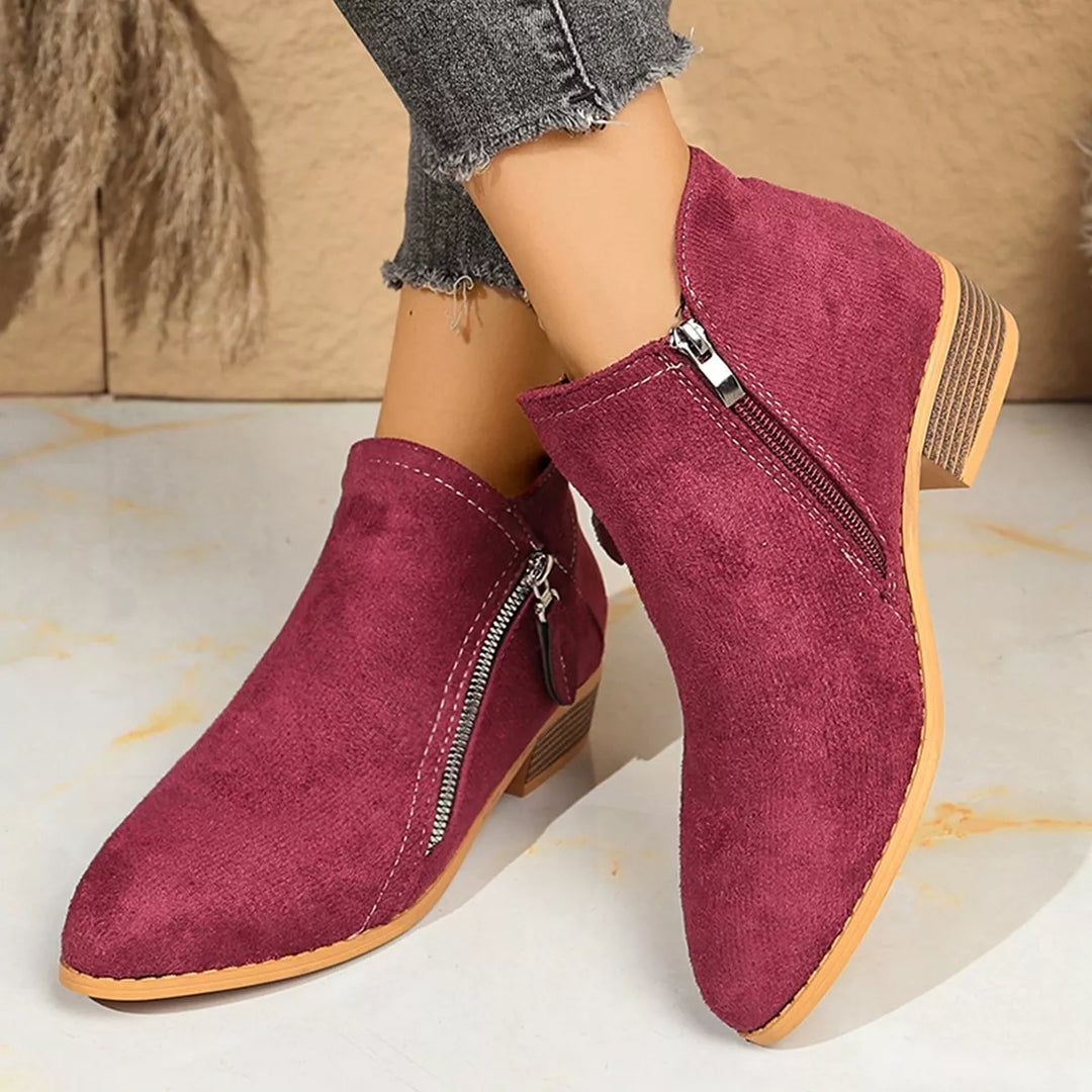 Burgundy ankle boots with side zip, worn with cuffed jeans