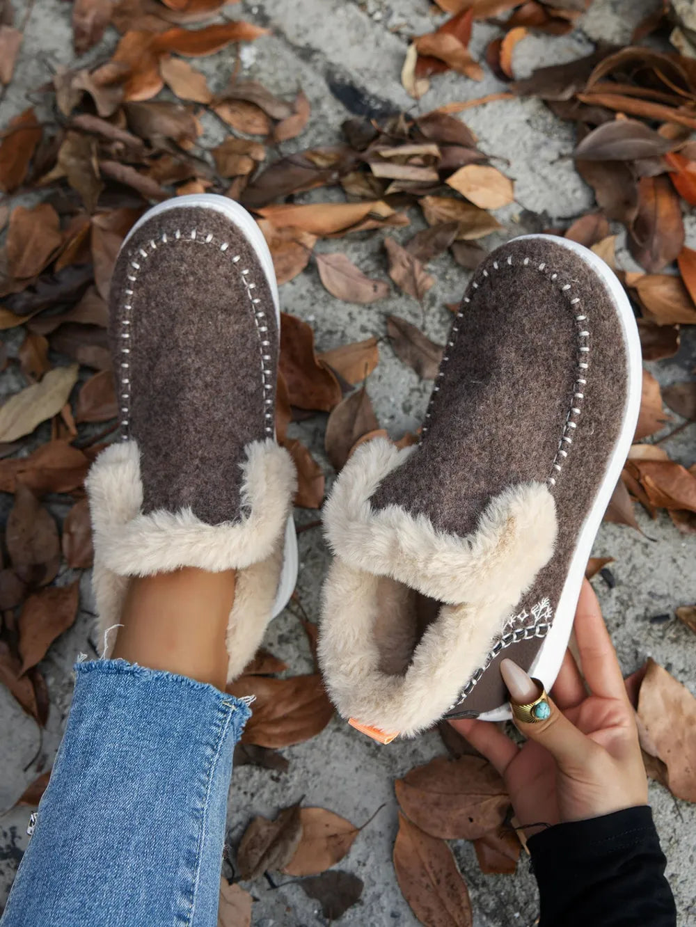 Brown ankle boots seen from above showing the soft fur-look lining