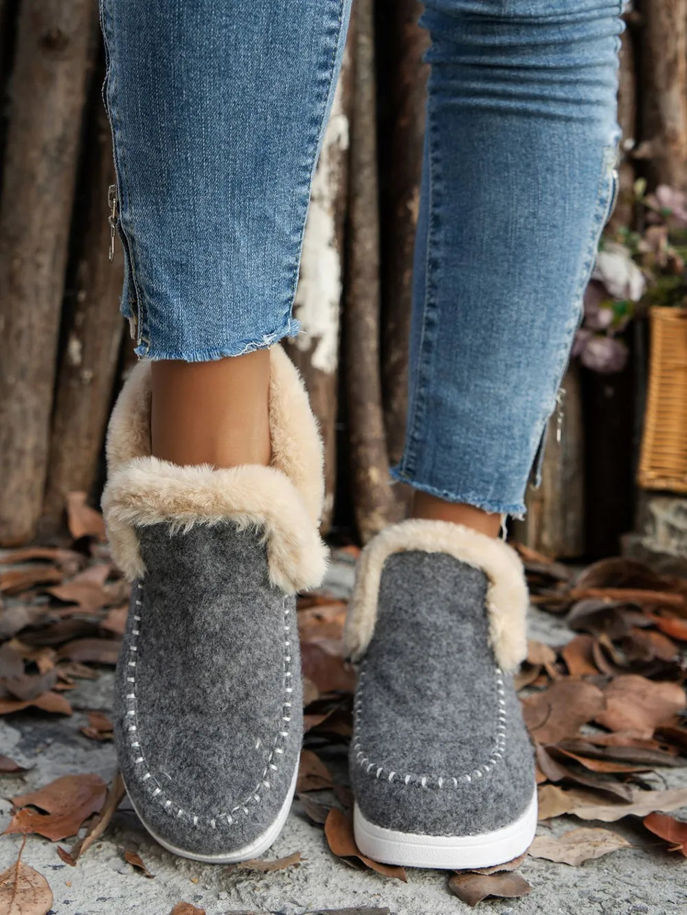 Gray ankle boots with fur-look cuff, front view of the pair on foot