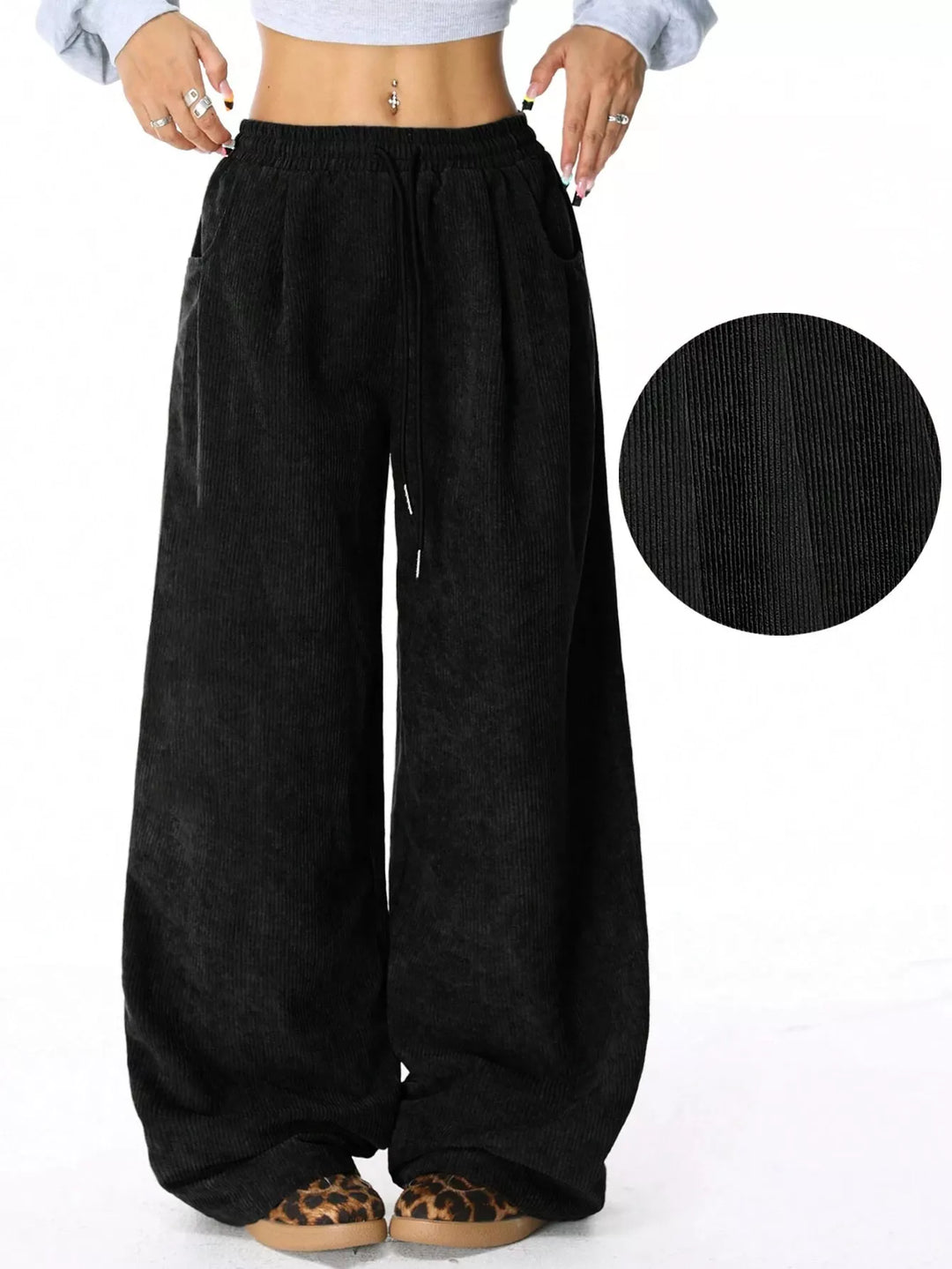 Black baggy pants with drawstring waist and fabric texture inset