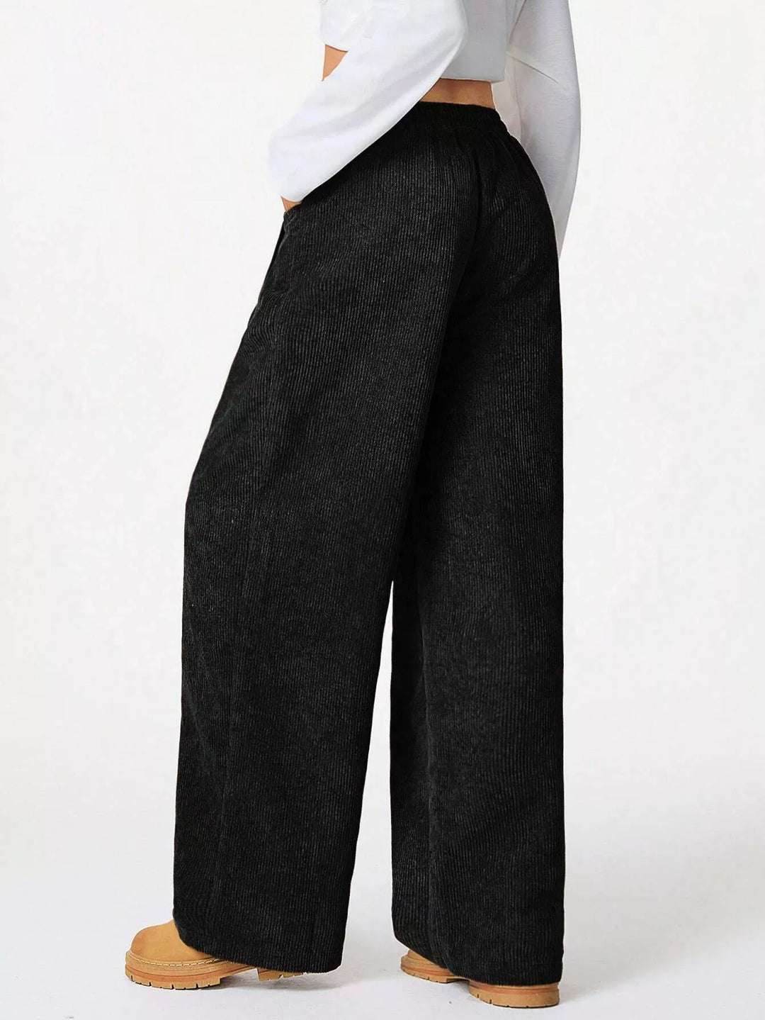 Side view of black wide leg pants with a relaxed fit