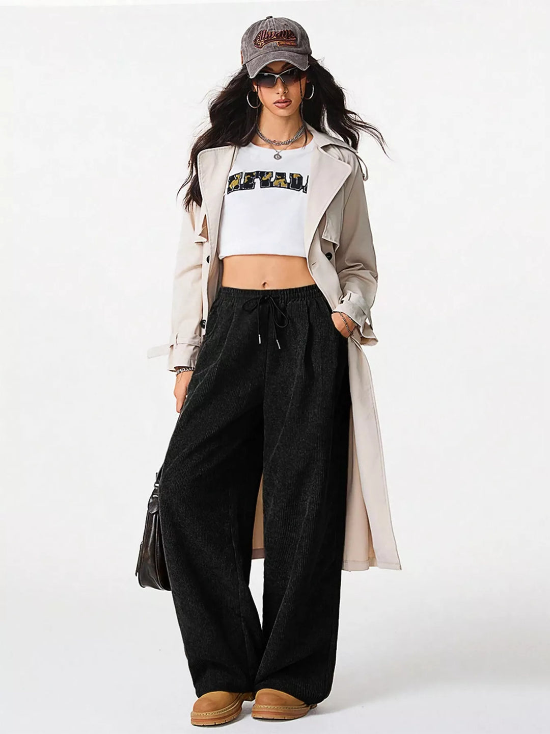 Black wide leg pants styled with a white crop top and long trench coat