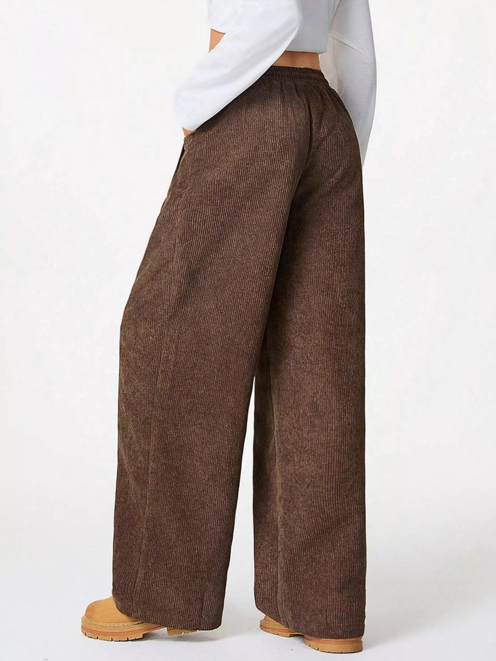 Side view of brown baggy pants with relaxed wide legs
