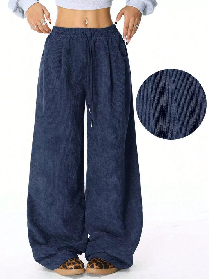 Navy baggy wide leg pants with drawstring and fabric texture inset