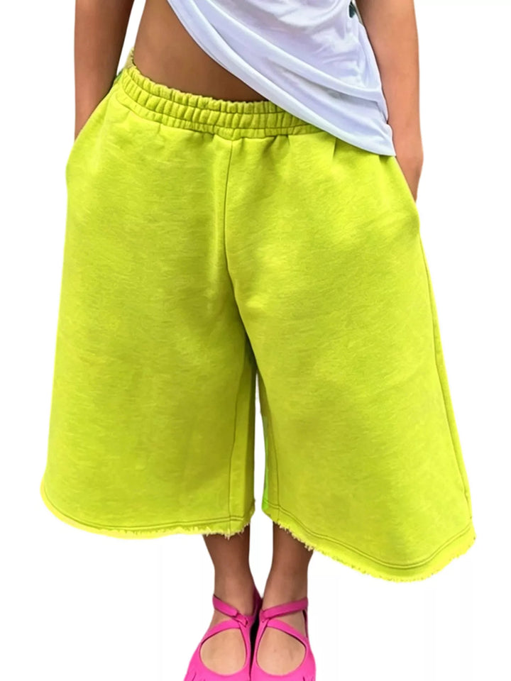 Neon lime wide leg knee length shorts with elastic waist and frayed hem