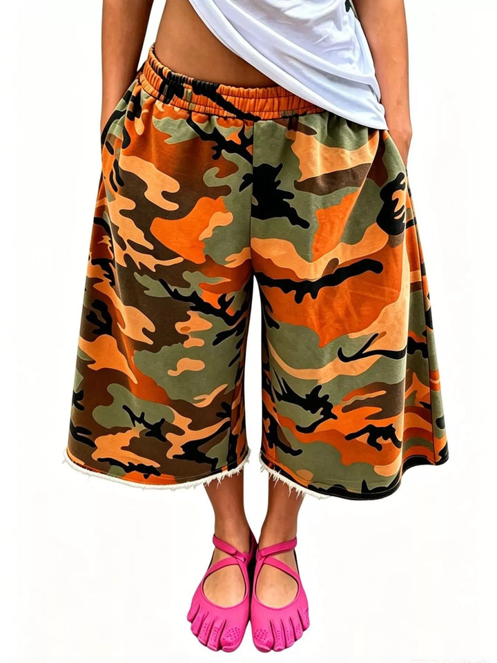 Orange camo wide leg shorts with frayed hem and elastic waistband
