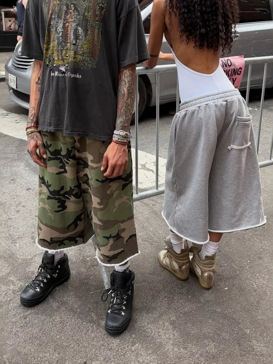 Woodland camo wide leg shorts on a street, paired with sneakers and a graphic tee