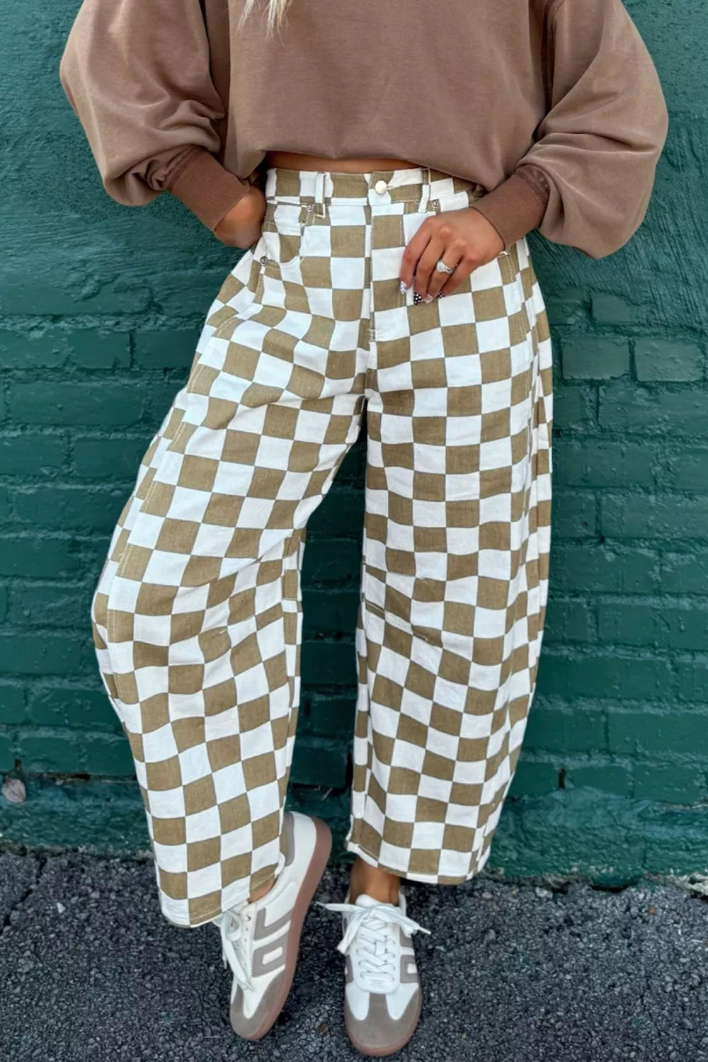 Women's barrel leg pants in khaki checkerboard print, high waisted, styled with sneakers