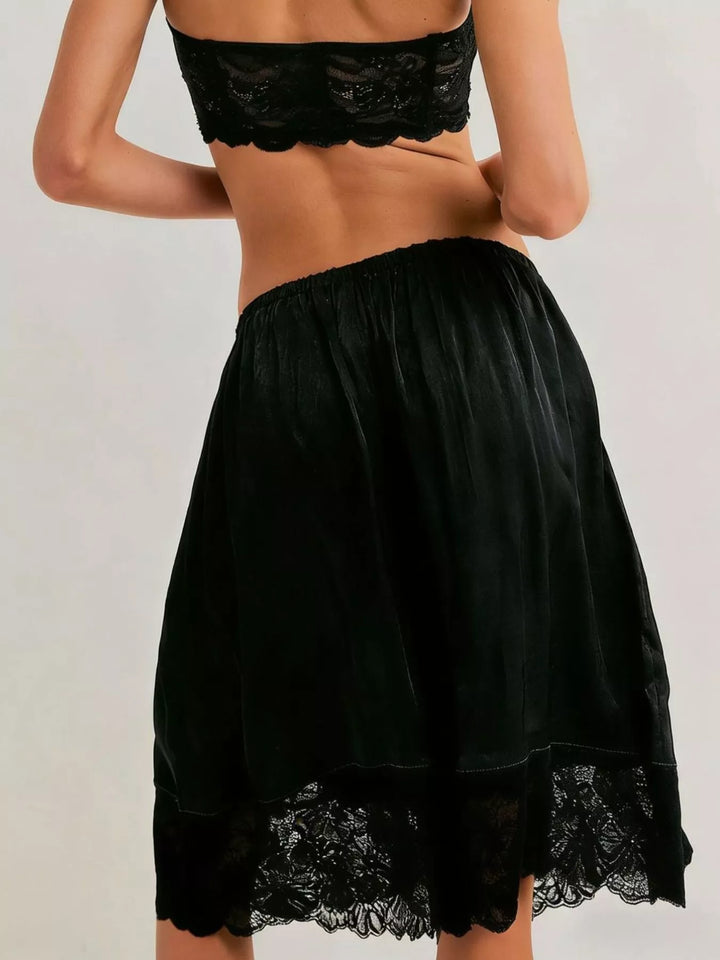 Back view of black Bermuda shorts with lace trim hem