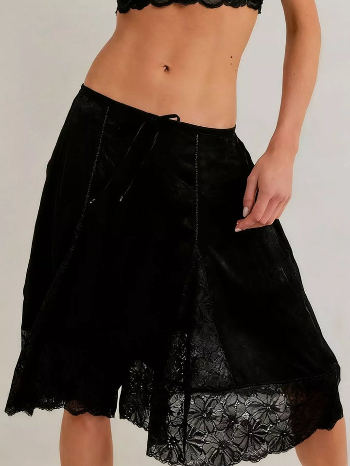 Black Bermuda shorts with lace trim hem, front view