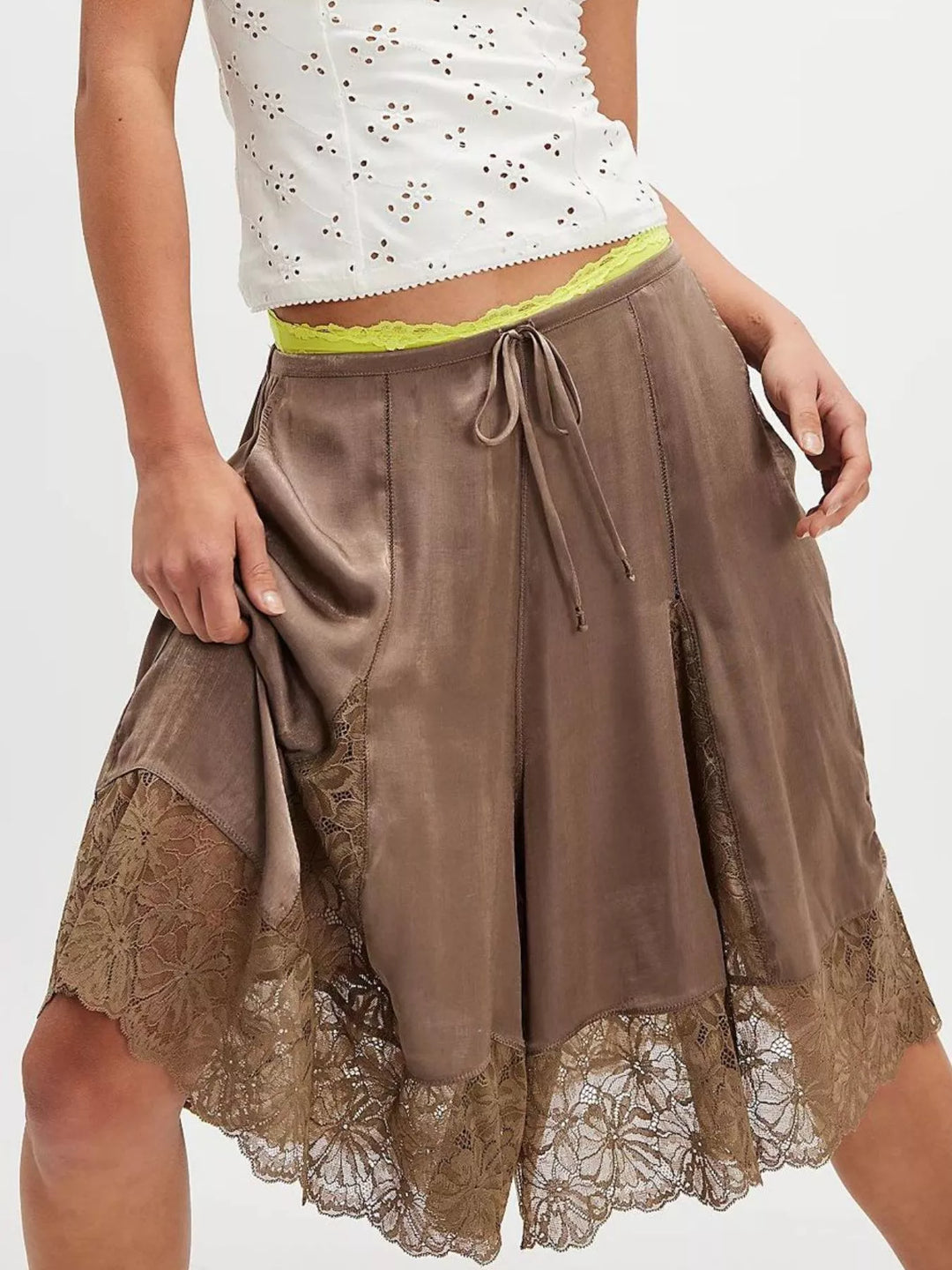 Brown Bermuda shorts with lace panels styled with a white eyelet top