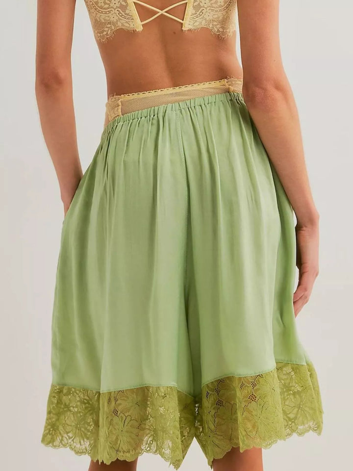 Back view of gum leaf green Bermuda shorts with lace hem