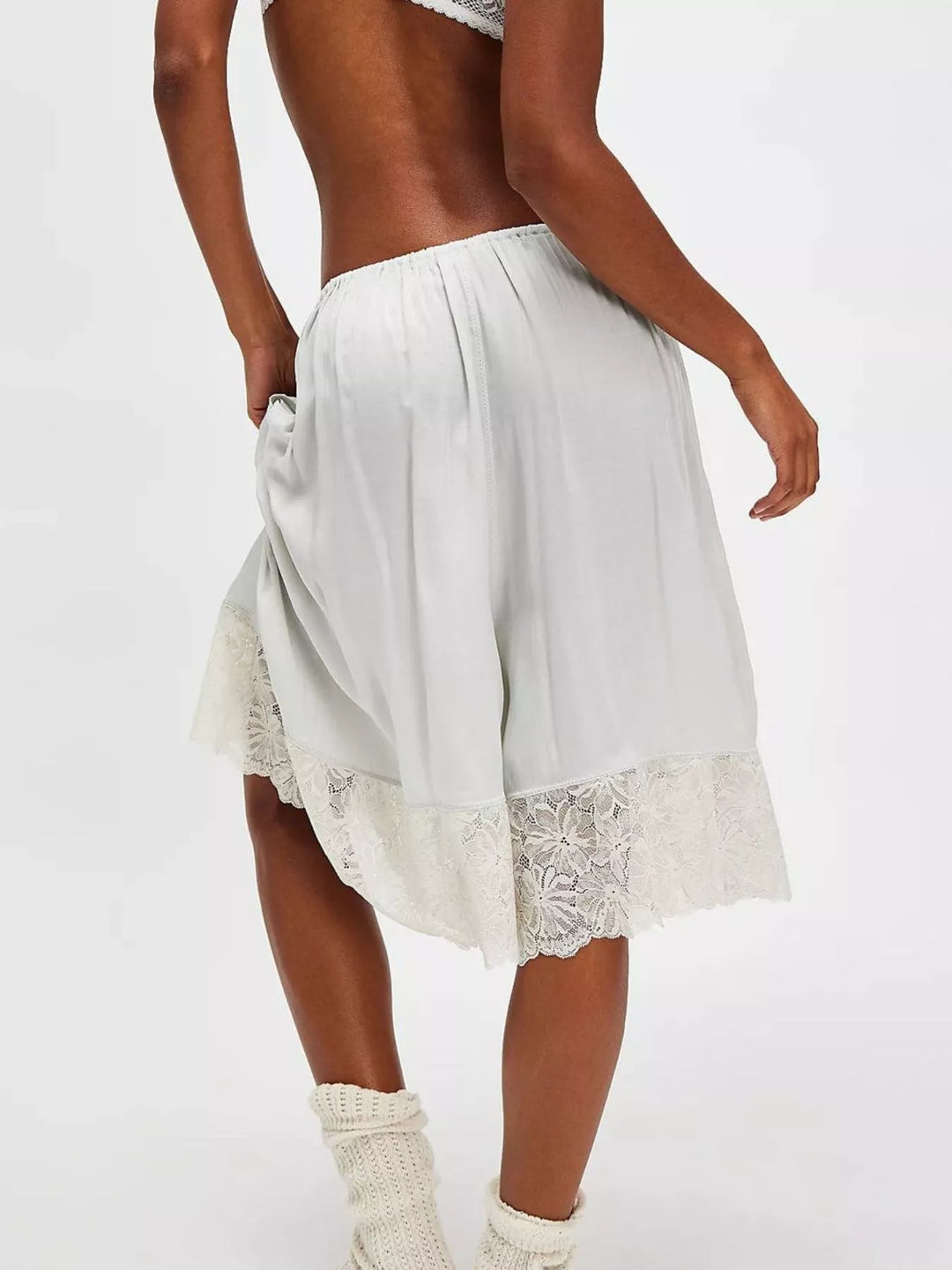 Back view of light gray Bermuda shorts with lace trim hem