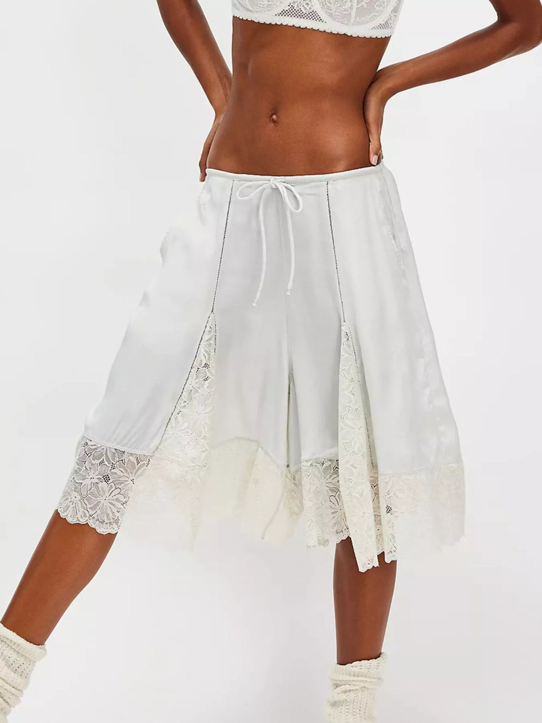 Light gray Bermuda shorts with ivory lace trim hem, front view