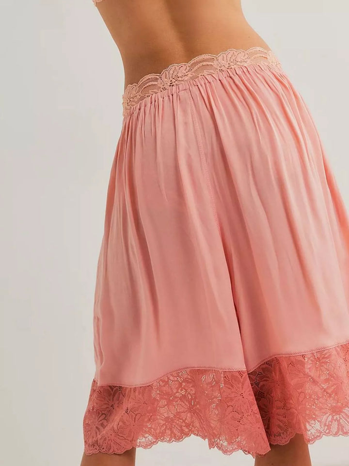 Back view of pink Bermuda shorts showing the lace trim hem