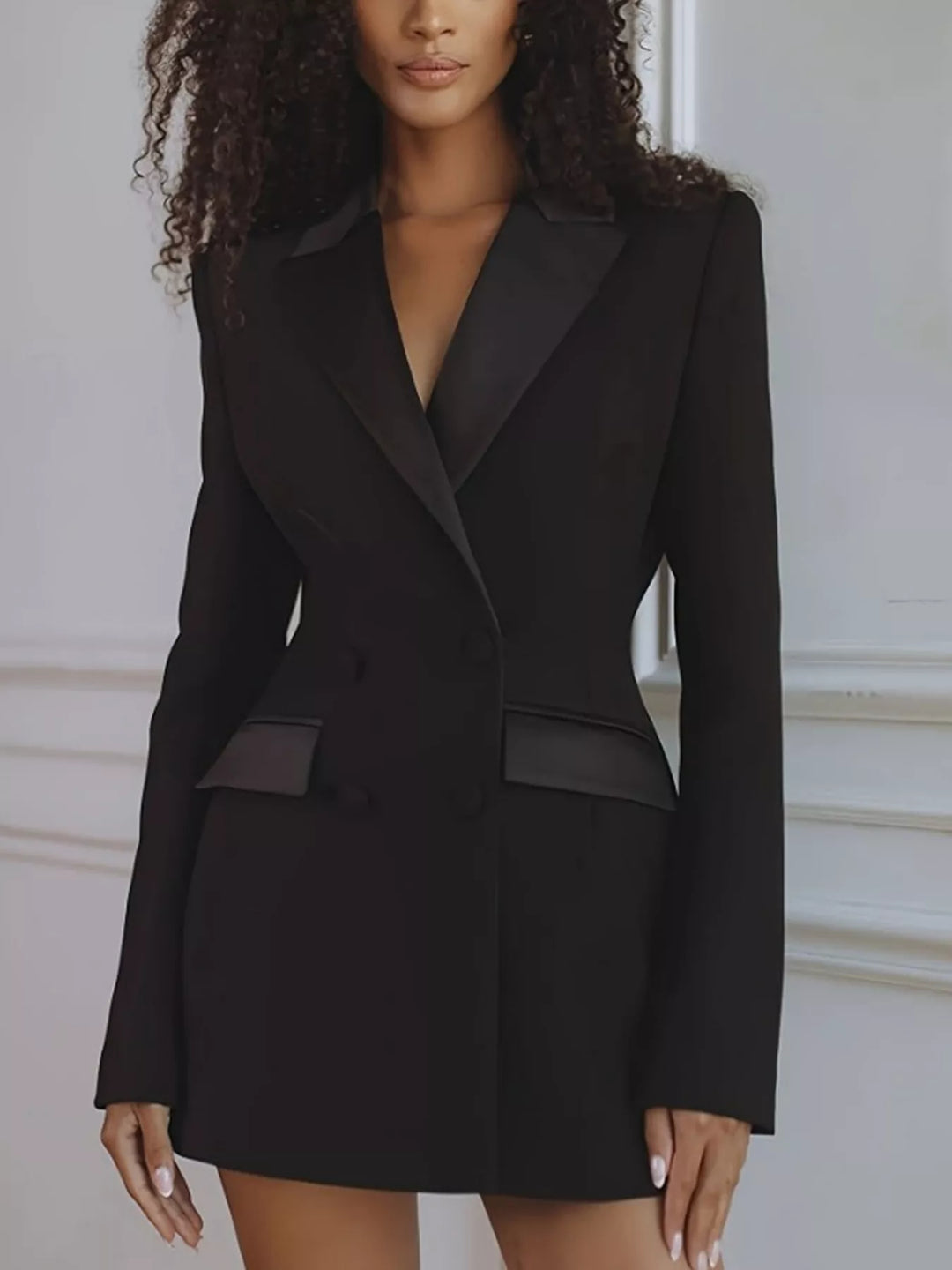 Black satin lapel blazer dress worn with long dark curly hair, front view