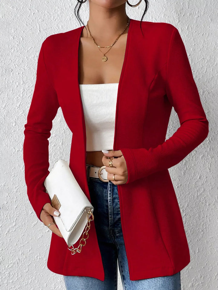 Red open front blazer styled with a clutch bag and jeans
