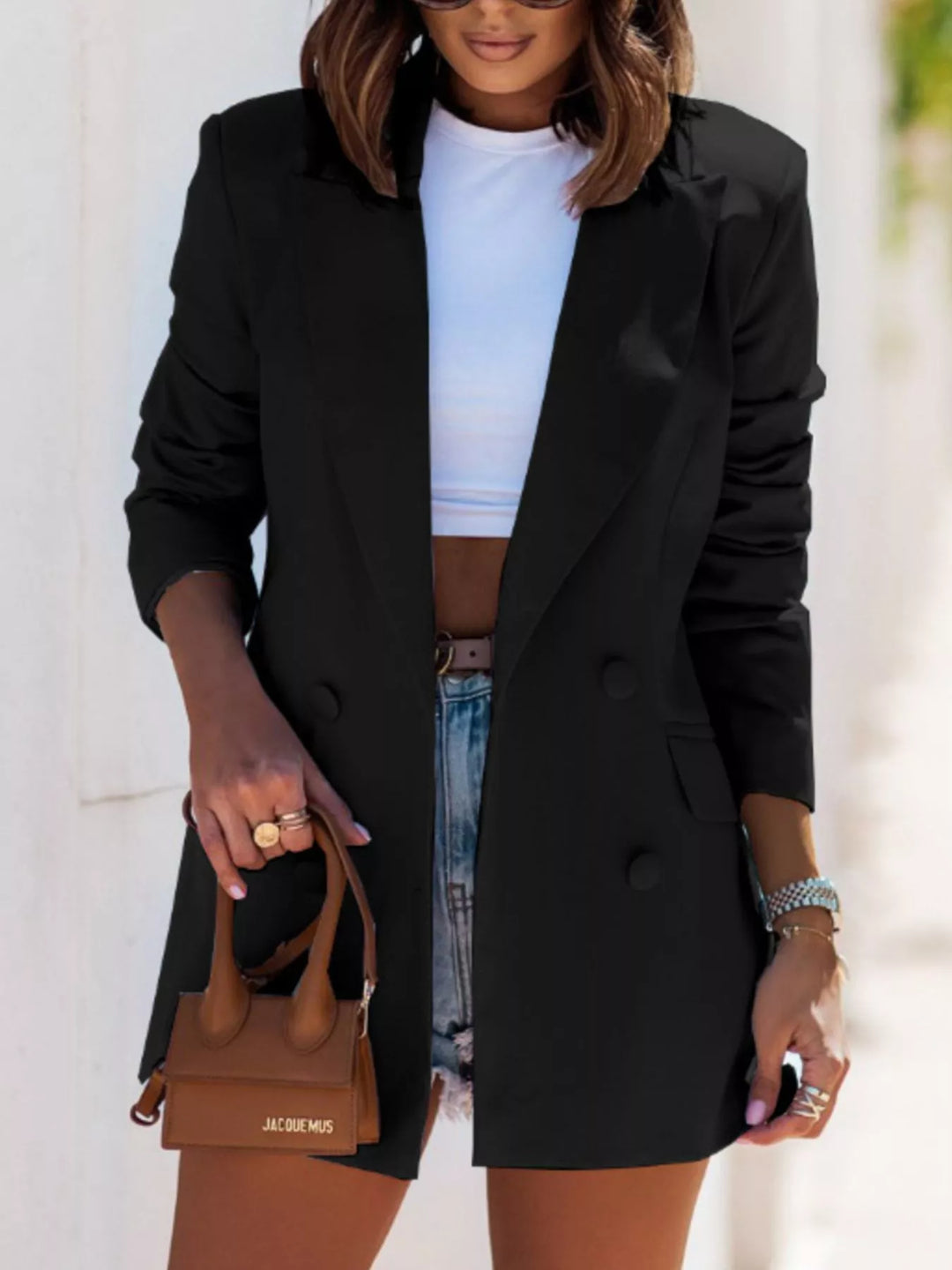 Black oversized double breasted blazer with white crop top and brown mini bag
