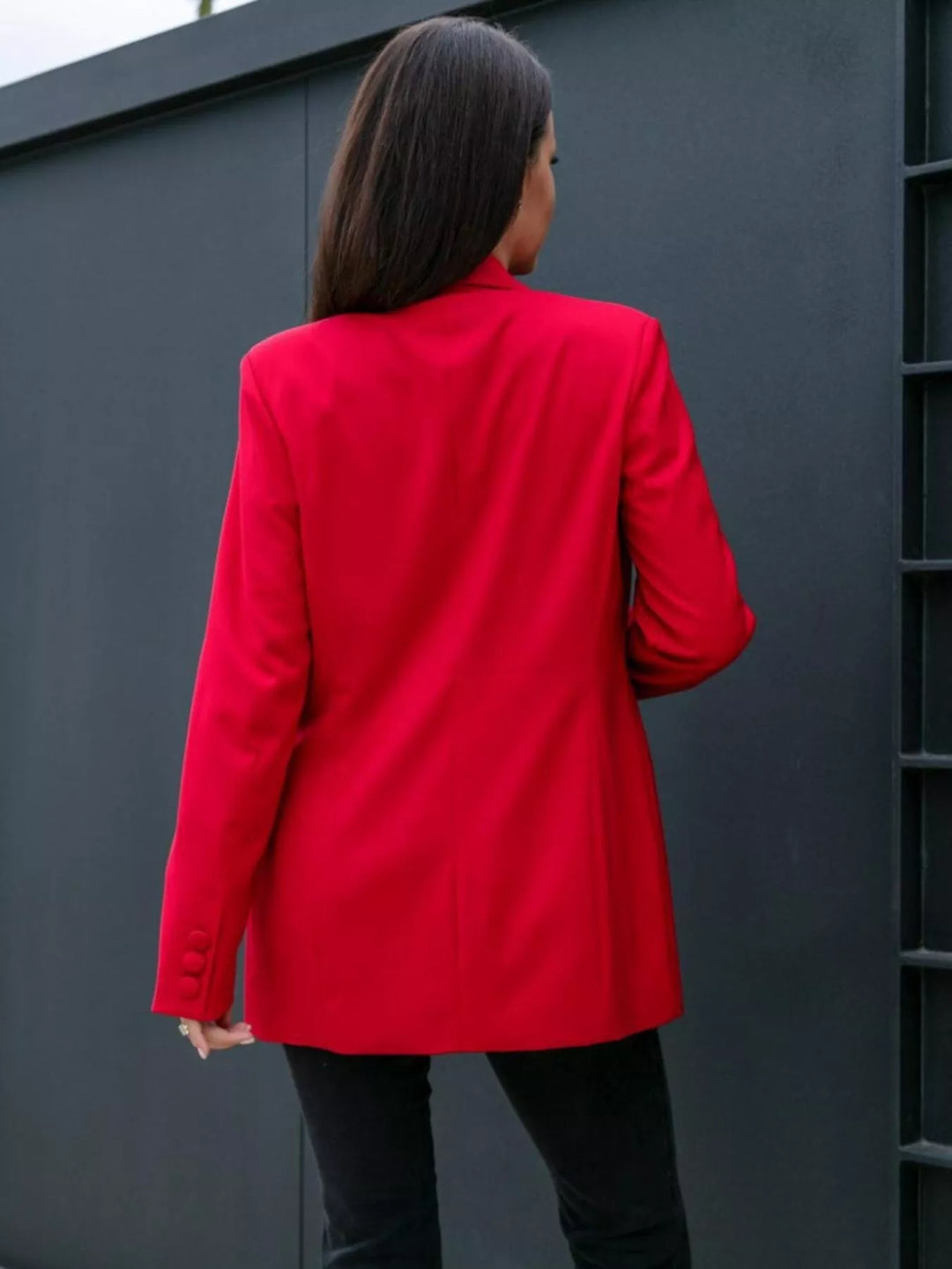Back view of the red blazer with straight long dark hair