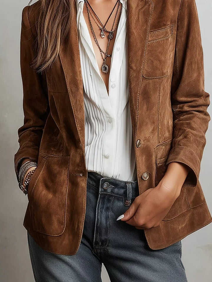 Cognac blazer styled with layered necklaces, white shirt and dark jeans