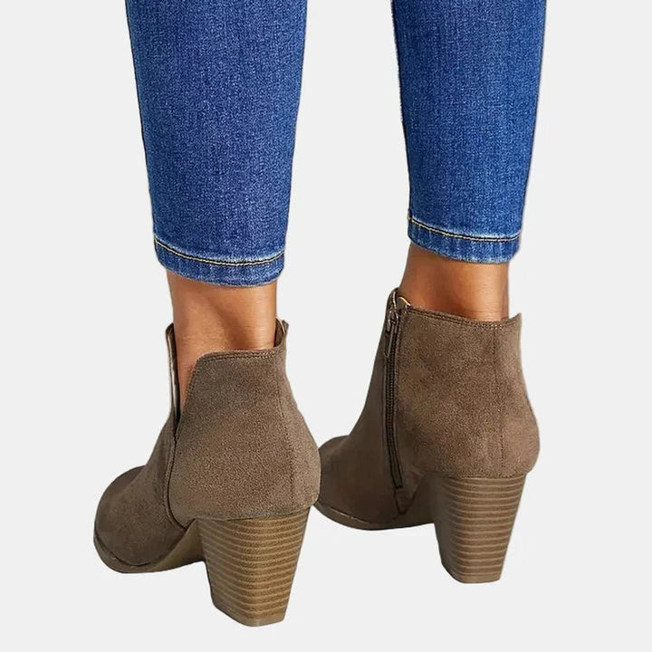 Back view of taupe ankle boots with inner zip and stacked heel
