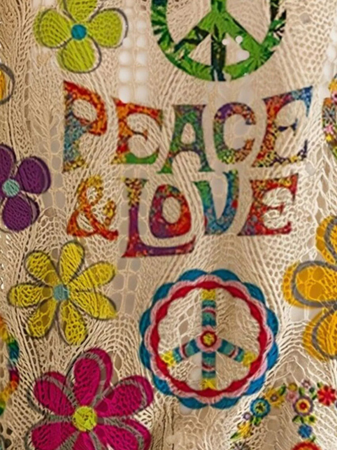 Close-up of the peace and love lettering with colorful flowers on the boho top