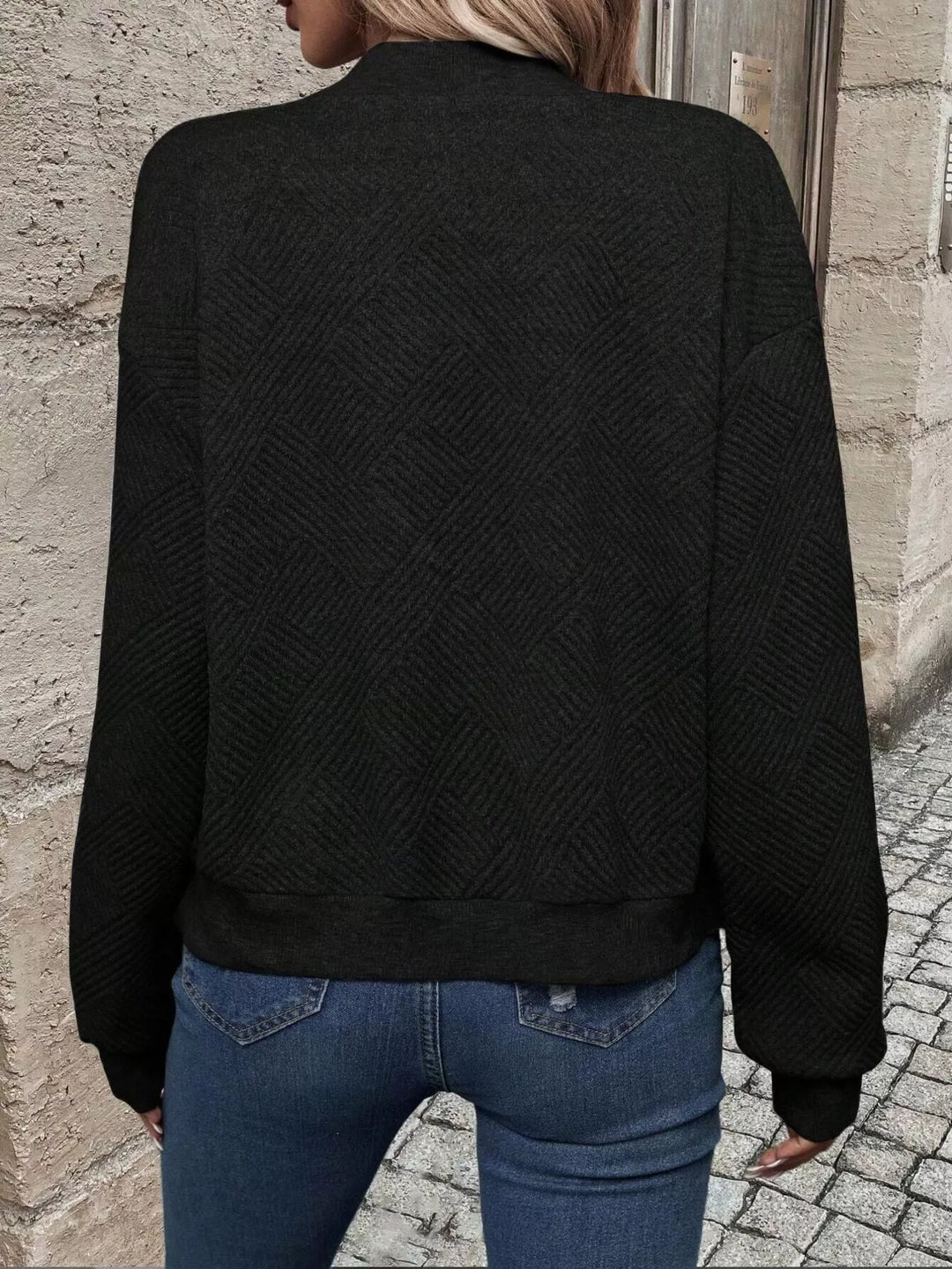 Back view of the black quilted diamond bomber jacket