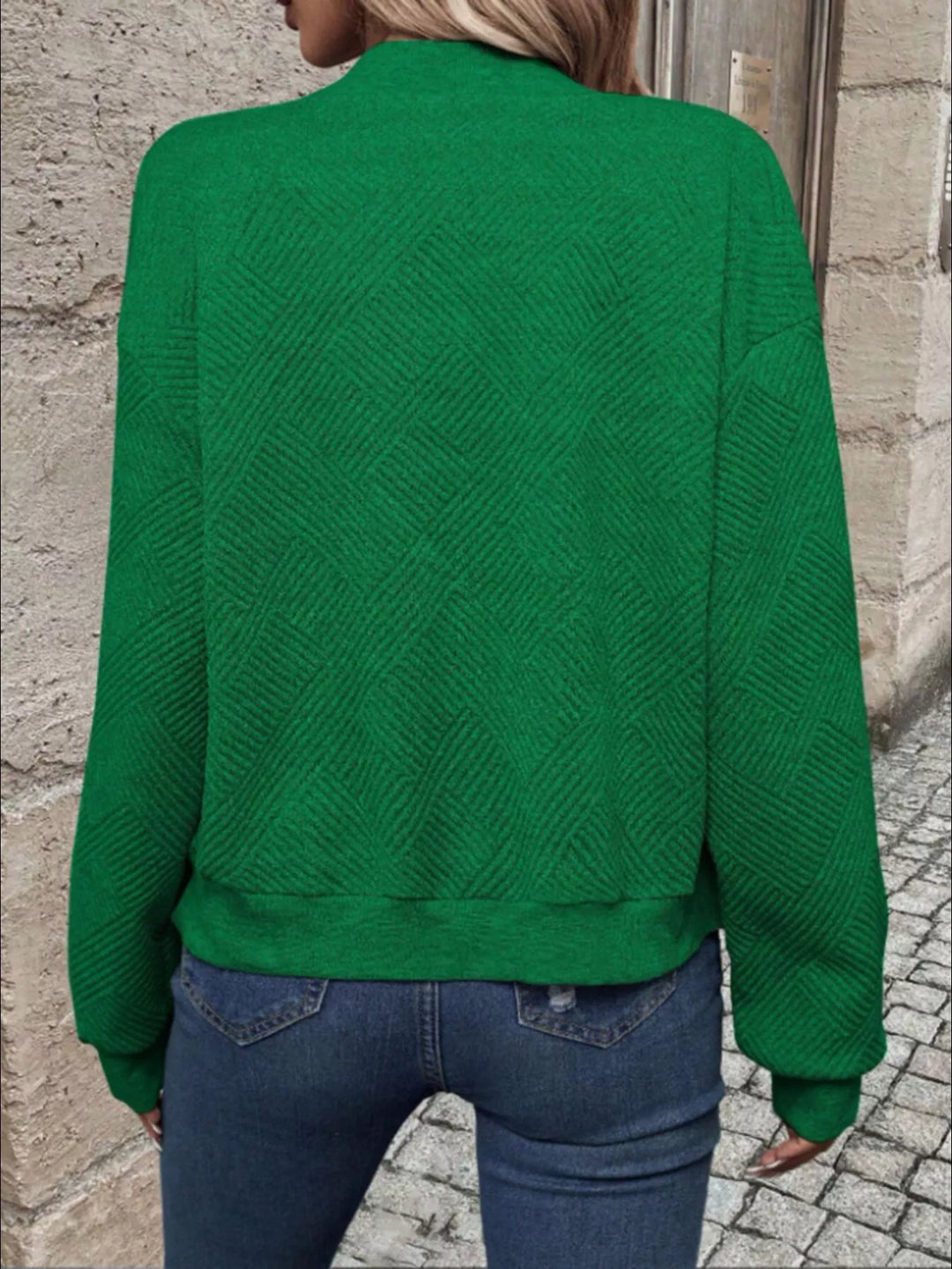 Back view of the emerald green cropped bomber jacket