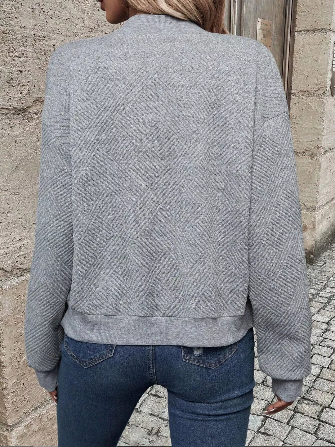 Back view of the light gray cropped bomber jacket