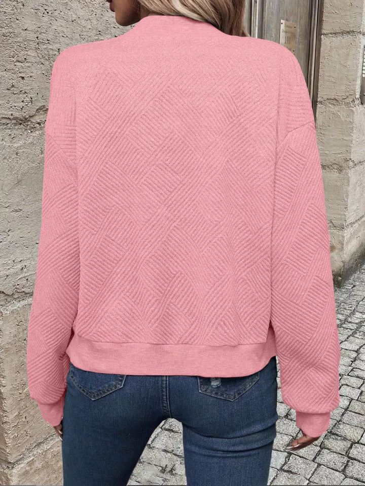 Back view of the pink cropped quilted bomber jacket