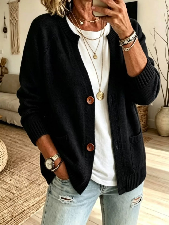 Black crew neck raglan cardigan with patch pockets, front view