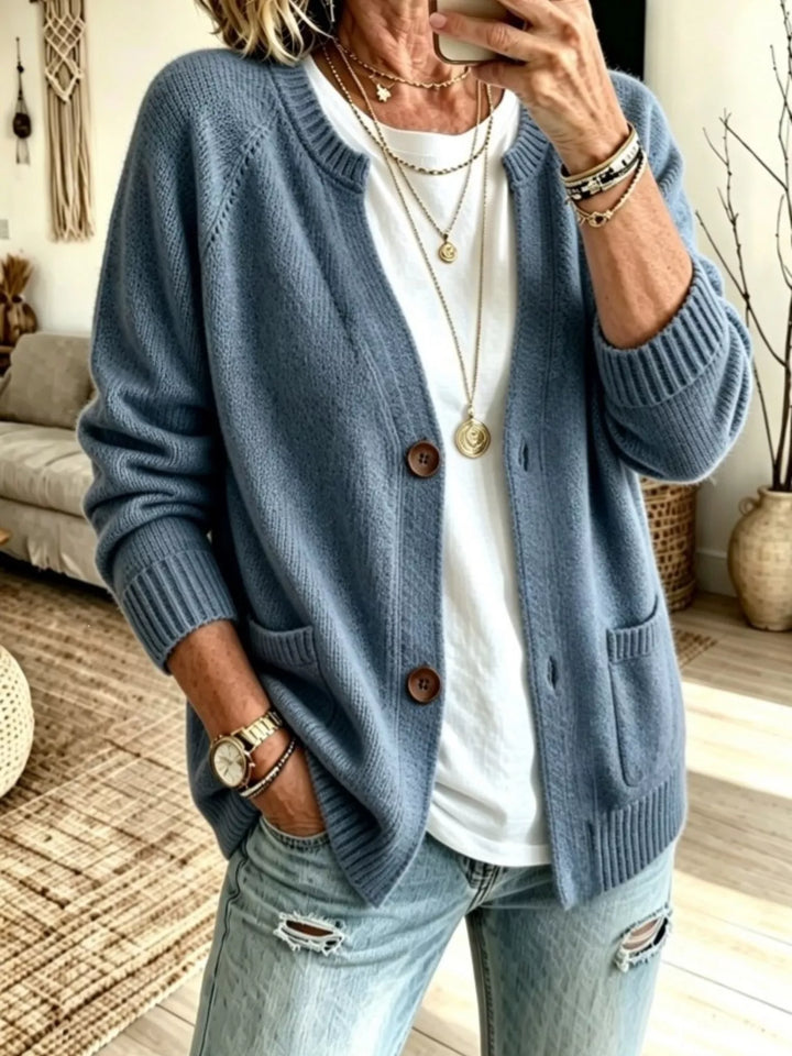 Dusty blue crew neck raglan cardigan with patch pockets, front view