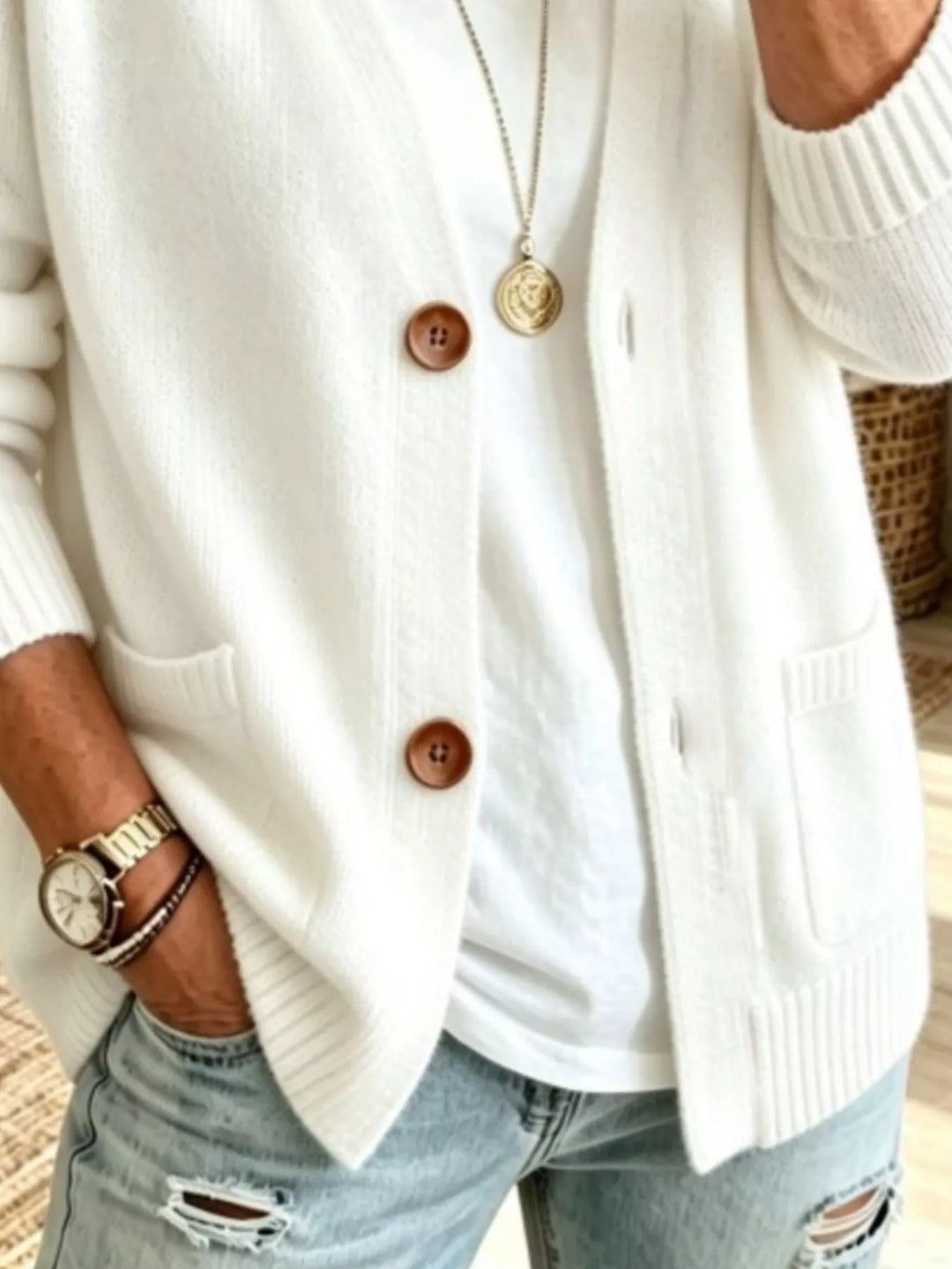 Detail of the white cardigan patch pockets and button front