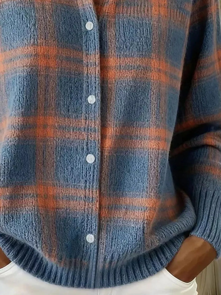 Detail of the slate blue plaid cardigan button placket and ribbed hem