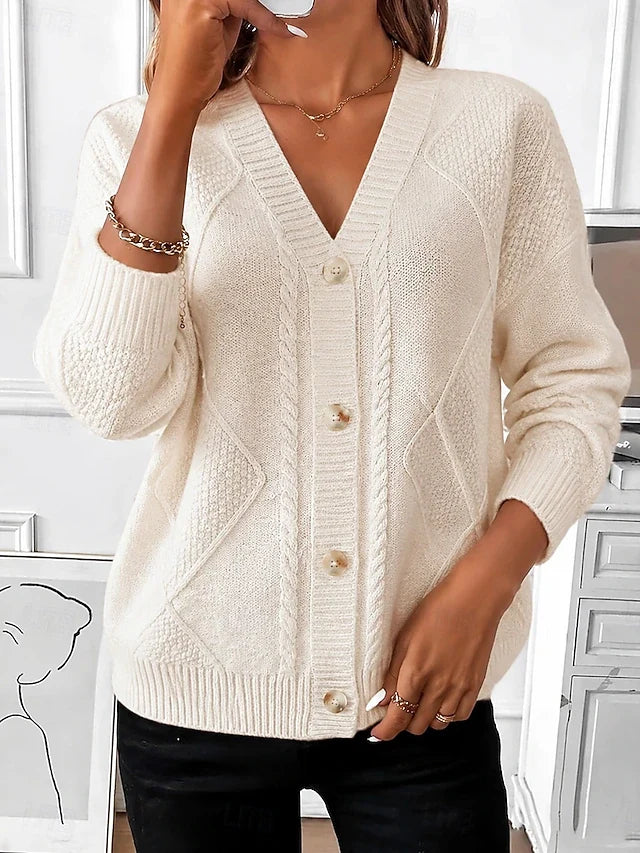 Model wearing the cream cable knit cardigan with a V-neck and button front