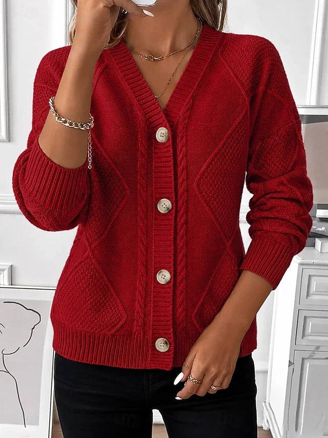 Model wearing the red cable knit cardigan with a V-neck and button front