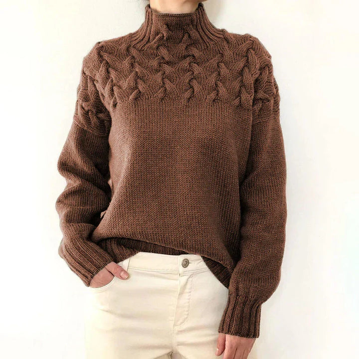 Model wearing the brown cable knit sweater with a mock neck and twisted cable yoke