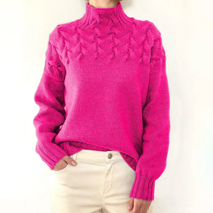 Model wearing the hot pink cable knit sweater with a mock neck and twisted cable yoke