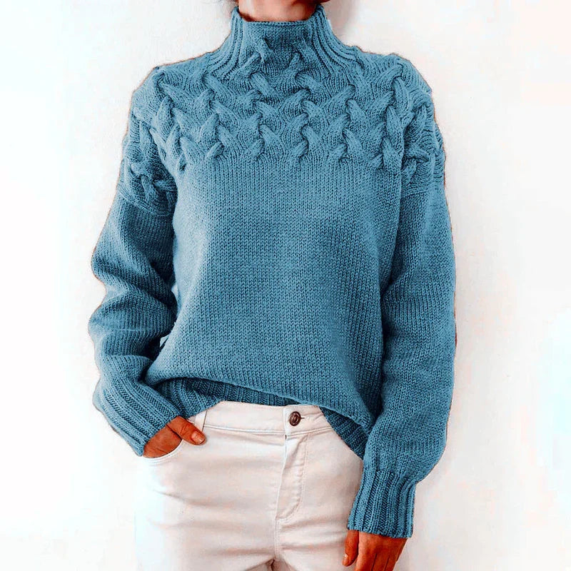 Model wearing the light blue cable knit sweater with a mock neck and twisted cable yoke